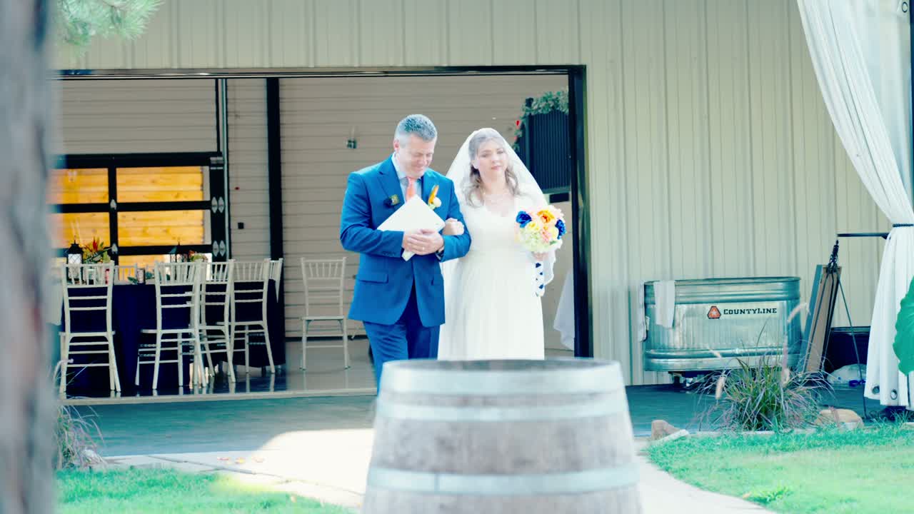 A bride walking toward an outdoor wedding ceremony
